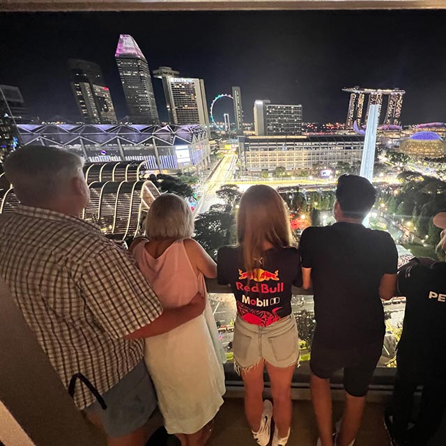 guests on a balcony overlooking singapore